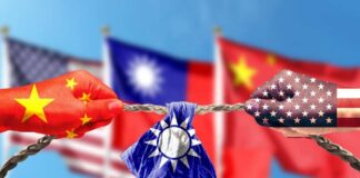 Hands painted with flags of China and the USA pulling a torn Taiwan flag