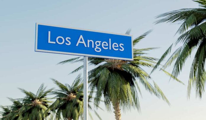 Sign indicating Los Angeles with palm trees in the background