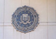 Surveillance Dragnet Looms Over World Cup FBI seal mounted on a wall, representing the Federal Bureau of Investigation