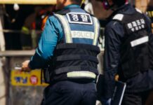 Police officers in protective vests at a scene