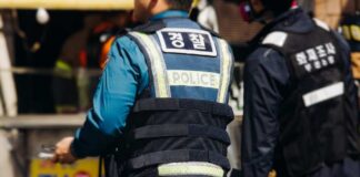 Police officers in protective vests at a scene