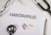 Document titled 'HANTAVIRUS' surrounded by medical tools and paper clips
