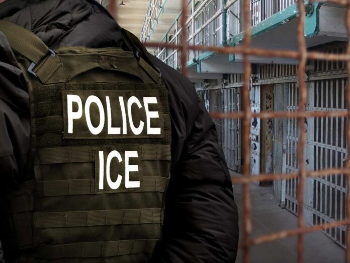 shutterstock_2738701697.jpg Police officer in tactical gear standing in a detention center