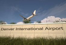 Sign for Denver International Airport with an airplane flying overhead
