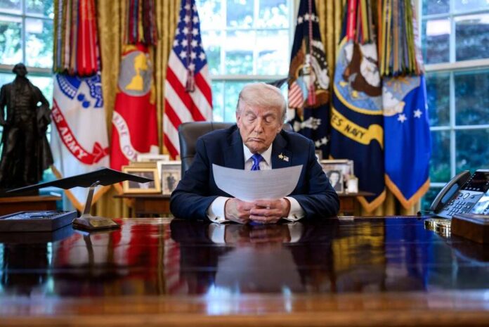 A political leader reading documents in the Oval Office