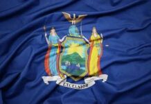 New York State flag with coat of arms on blue field