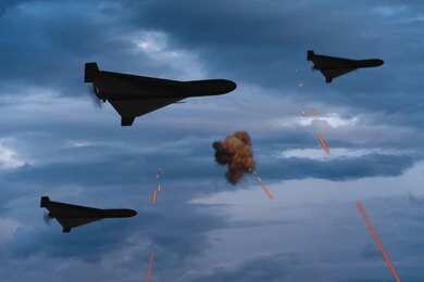 2656305537 Three military drones fly through a cloudy sky amid anti-air fire