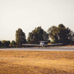 Skydivers Downed After Sudden Twist A small airplane on a runway surrounded by trees