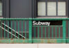Hate-Fueled Subway Attack Stuns NYC Subway entrance with a green railing and a sign reading Subway