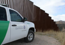 Zero Releases Claim Sparks Border Uproar U.S. Customs and Border Protection vehicle parked near a border wall in a desert area