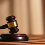 Shocking School Stabbing Videos Released A wooden gavel resting on a circular base with soft lighting
