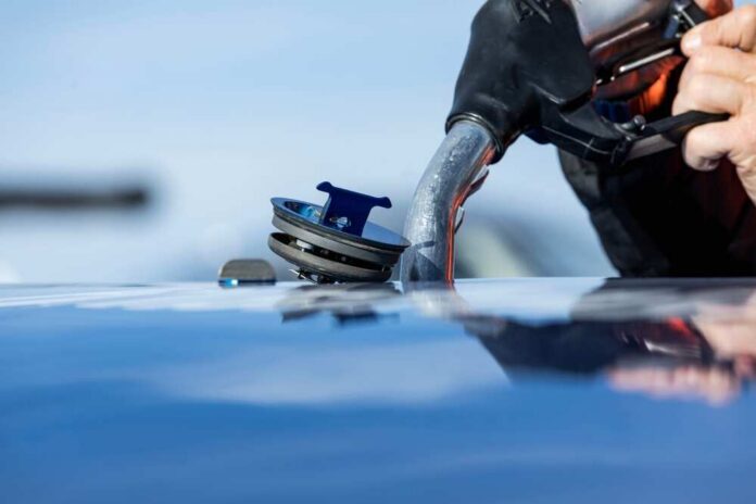 Refueling,The,Plane.,The,Fbo,Refuels,The,Business,Aircraft,Before Close-up of a person refueling a vehicle at a gas station