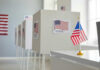Voting booths with American flags in a polling station