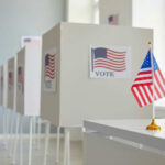 Why Americans Doubt Election Results Voting booths with American flags in a polling station
