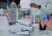 Ballot Glitch Sparks LA Meltdown Person casting a vote into a transparent ballot box during an election