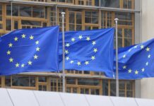 Europe’s Border Pivot Mirrors Trump Three European Union flags waving in front of a building