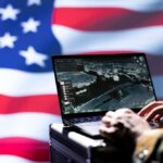 Apache Down—Now Missiles Fly Laptop with surveillance software against a blurred American flag