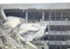 Damaged building structure with exposed debris and scaffolding