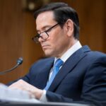 Old Rubio Video Hijacks Iran Deal Drama Individual in a suit reviewing documents during a senate hearing