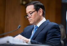 Old Rubio Video Hijacks Iran Deal Drama Individual in a suit reviewing documents during a senate hearing