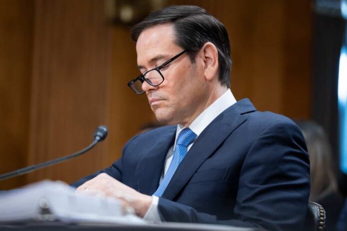 Washington,,Dc,,United,States,-,May,20,,2025:,Secretary,Marco Individual in a suit reviewing documents during a senate hearing