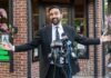 NYC Expands Sanctuary City Protections Man in a suit speaking at a press conference with microphones in front of him