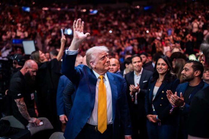 President,Trump,Attends,Ufc,314,In,Miami,,Florida,-,April A man in a blue suit with a yellow tie waves to a cheering crowd