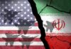 A cracked wall featuring the flags of the USA and Iran with military aircraft silhouettes