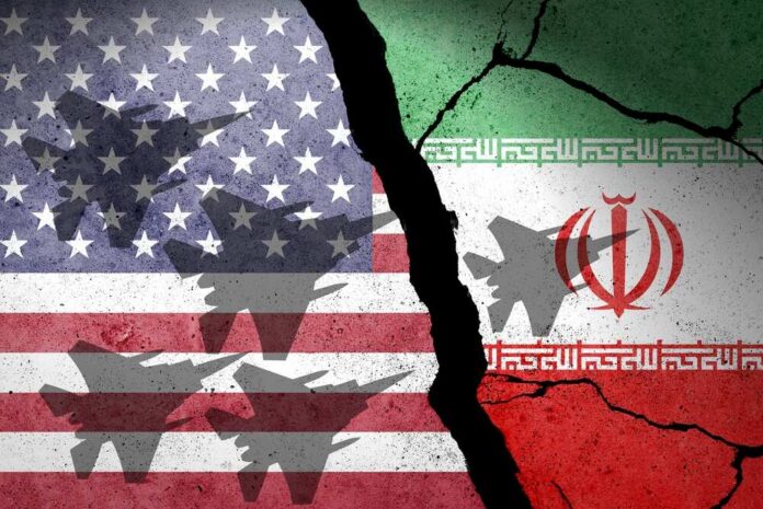 A cracked wall featuring the flags of the USA and Iran with military aircraft silhouettes