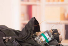 A backpack containing a mobile phone and wires, suggesting a suspicious setup