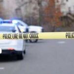 Unsecured Gun Kills Georgia Toddler Police tape cordons off a street with patrol cars in the background