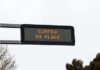Electronic road sign displaying curfew notice