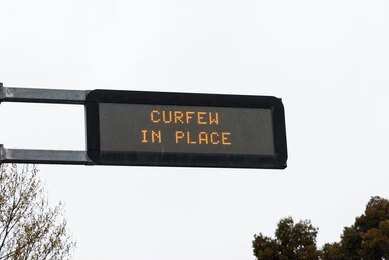 Electronic road sign displaying curfew notice