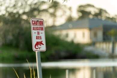 2401591579 A high water warning sign near a flooded area