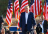 Republicans Launch Historic New Strategy A speaker at a political rally surrounded by American flags and an engaged crowd