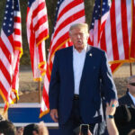 Republicans Launch Historic New Strategy A speaker at a political rally surrounded by American flags and an engaged crowd