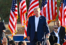 Republicans Launch Historic New Strategy A speaker at a political rally surrounded by American flags and an engaged crowd