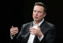 A business leader speaking during an interview, using hand gestures for emphasis