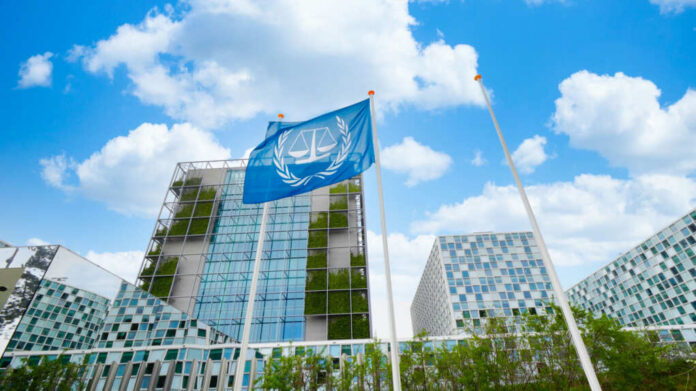 shutterstock2411864493jpg Modern building with UN flag in front under a blue sky with clouds