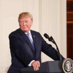 man at podium with presidential seal