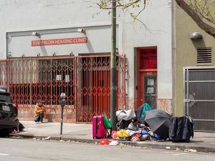 shutterstock_1094612630 Sidewalk scene outside a housing clinic with people and belongings