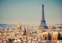 A panoramic view of Paris featuring the Eiffel Tower and a golden dome
