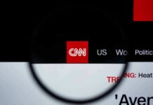 CNN’s Goalposts Drama Explodes CNN logo on a website header viewed through a magnifying glass