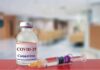 vaccine vial and syringe on a counter in a clinic