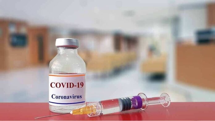 shutterstock_1643122693 vaccine vial and syringe on a counter in a clinic