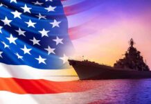 U.S. Navy Goes All-In On AI United States flag overlay with a naval warship at sunset on the ocean