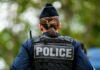 Viral Clip Triggers Policy Change Back view of a police officer wearing a uniform and a police vest