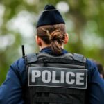 Viral Clip Triggers Policy Change Back view of a police officer wearing a uniform and a police vest