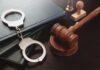 Felony Judge Avoids Prison After Conviction Handcuffs and a gavel on a desk with legal books