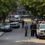 Bodycam Reveals Wild Escape Gone Wrong Police officers secure a residential street with patrol cars and yellow tape
